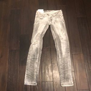 Acid wash jeans with intentional distressing